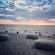 3 large and smooth stones on a rocky shore